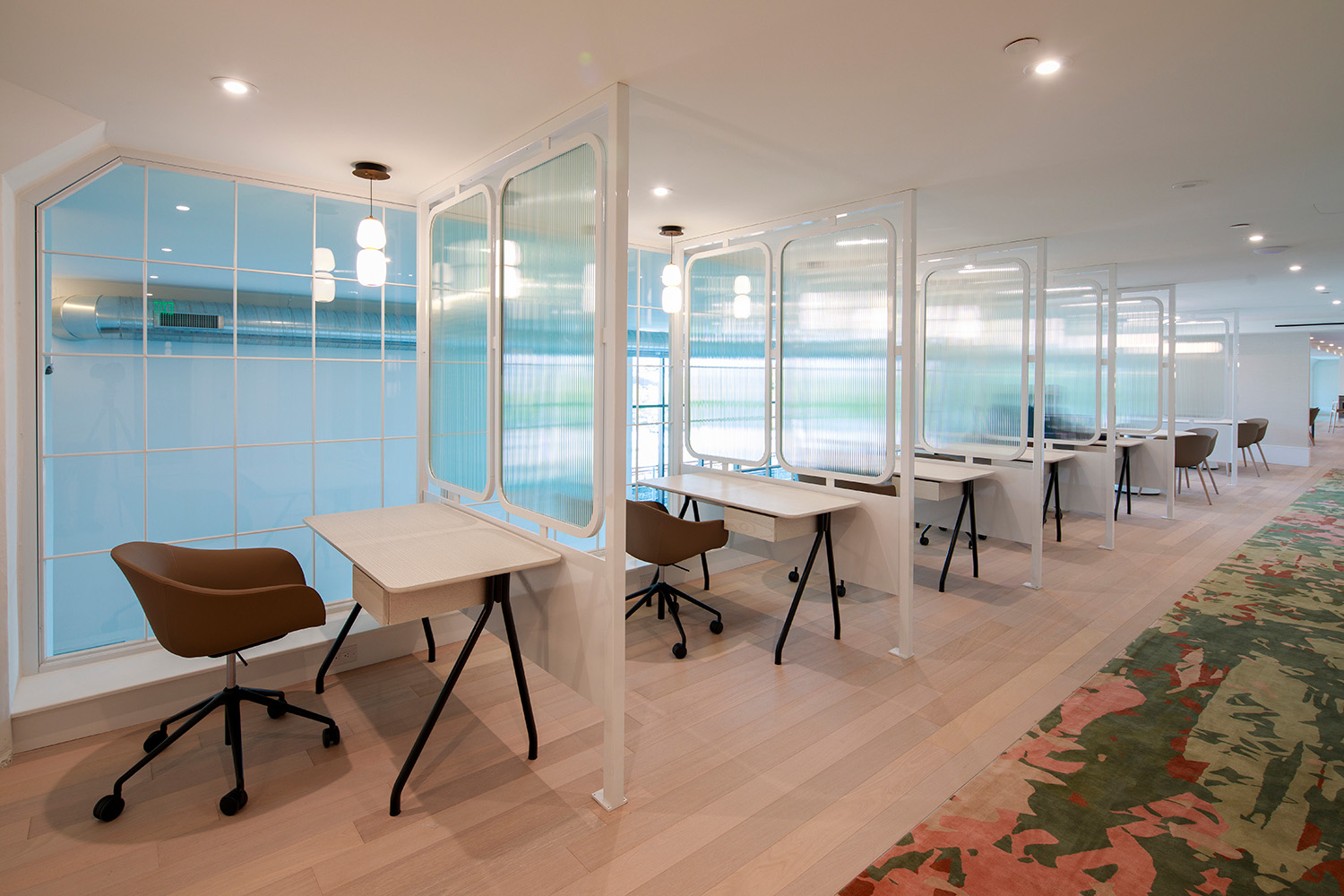 Co-working space with workstations that have semi-opaque glass dividers