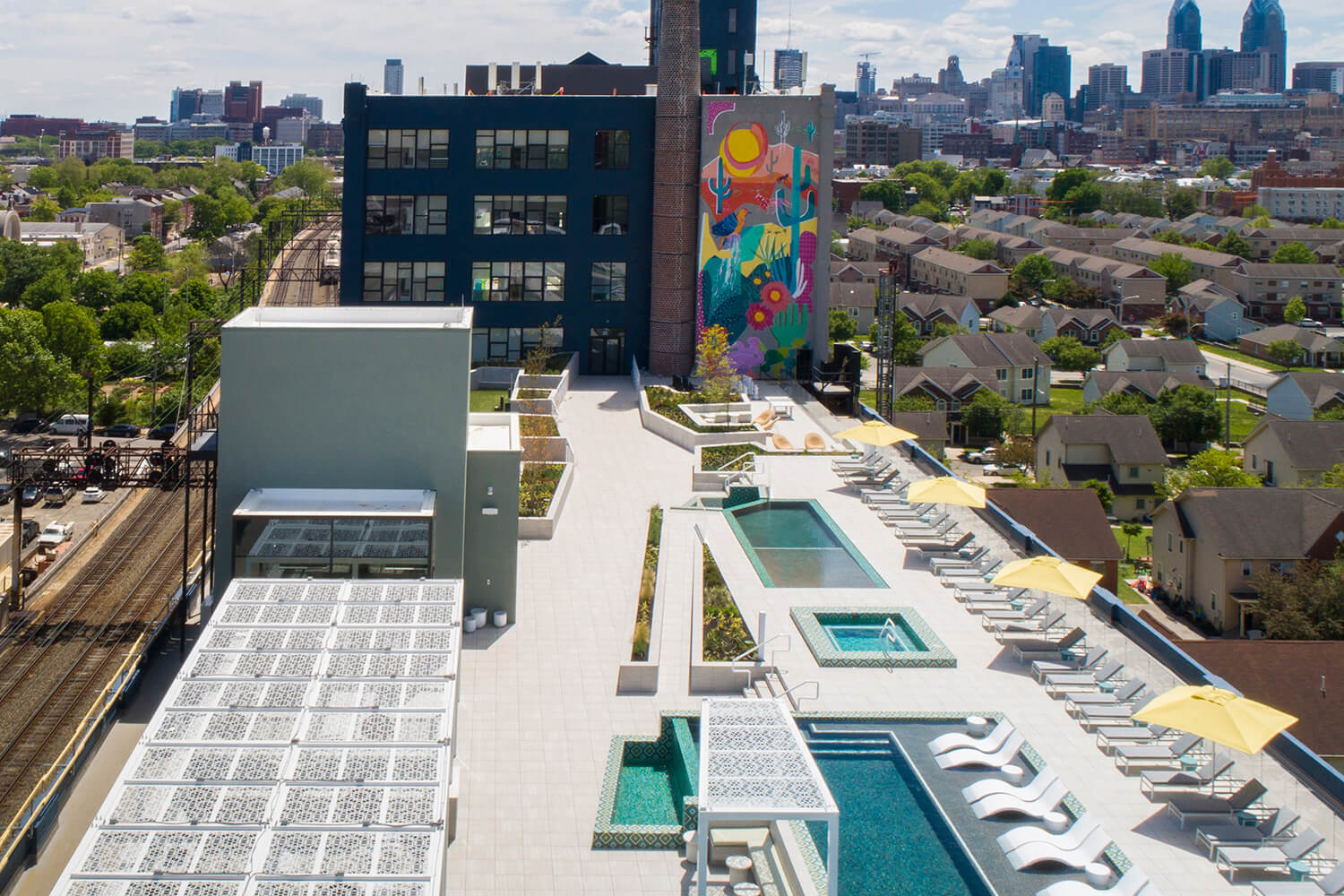 Aerial shot of rooftop with pools, private cabanas, and lounge chairs